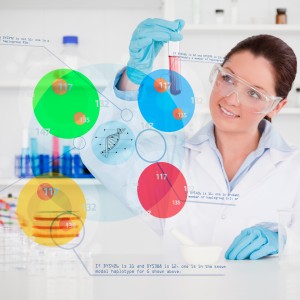 Smiling chemist looking at test tube with colourful holographic interface